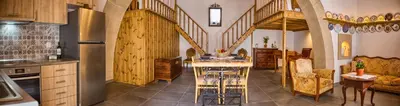 a kitchen with a spiral staircase in a house at Stone Arch in Malona Village