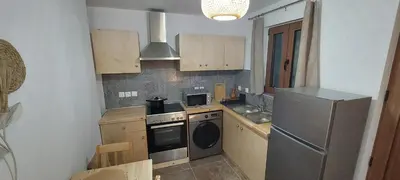 a small kitchen with a stove and a refrigerator at Lindos Alley in Líndos