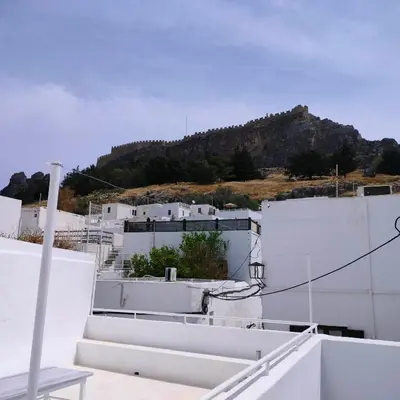a view from the roof of a building with a mountain in the background at Lindos Alley in Líndos