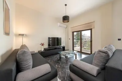 a living room with two couches and a tv at Adelais Luxury City Apartment Rhodes in Rhodes Town