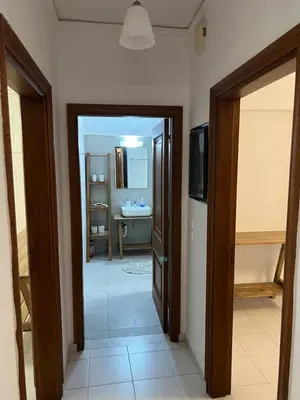 a hallway leading to a bathroom with a sink at Johannes House in Afantou