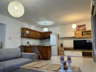 a living room with a couch and a kitchen at Johannes House in Afantou
