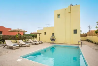 a swimming pool in front of a house at Villa Asteria in Gennadi