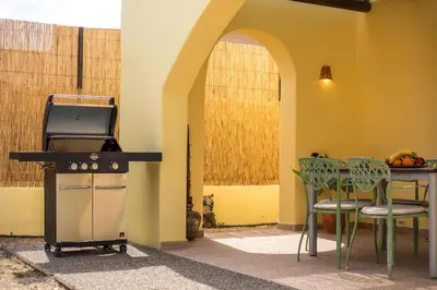 a kitchen with a stove and a table and chairs at Villa Asteria in Gennadi