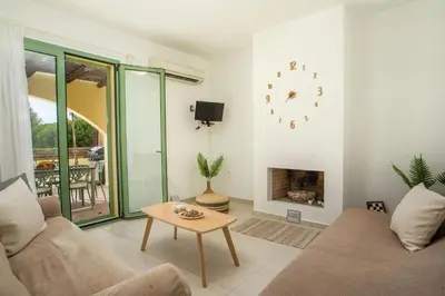 a living room with a couch and a fireplace at Villa Asteria in Gennadi