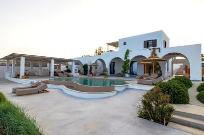 a house with a swimming pool in a courtyard at Beachfront Villa Crystalia in Lachania
