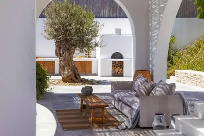 a living room with a couch and a table at Beachfront Villa Crystalia in Lachania