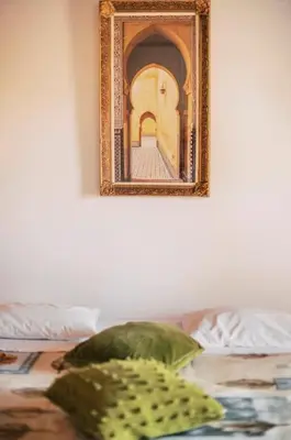 a picture hanging on a wall next to a bed at Kristinas View Studios in Rhodes Town