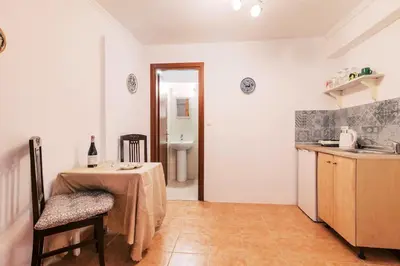 a kitchen with a table and a sink and a table and chair at Kristinas View Studios in Rhodes Town