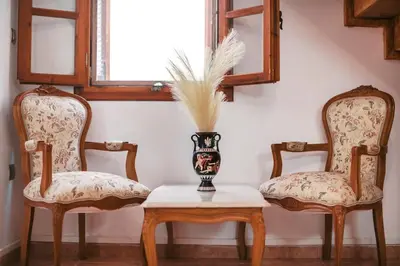 two chairs and a vase on a table in a room at Kristinas View Studios in Rhodes Town