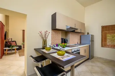 a kitchen with a counter top and a refrigerator at Alchadef Park Apartment in Rhodes Town