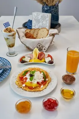 a table topped with plates of food and drinks at Old Town Luxury Velvet Apartment in Rhodes Town