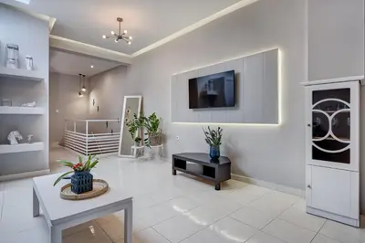 a living room with a tv on a wall at Old Town Luxury Velvet Apartment in Rhodes Town