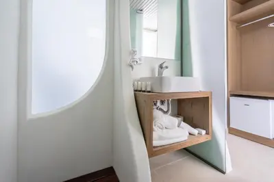 a bathroom with a sink and a mirror at Aloe Hotel - Adults Only in Faliraki