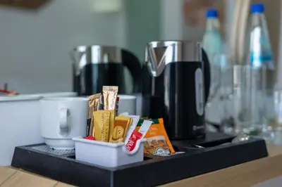 a counter top with a coffee maker and some food at Aloe Hotel - Adults Only in Faliraki