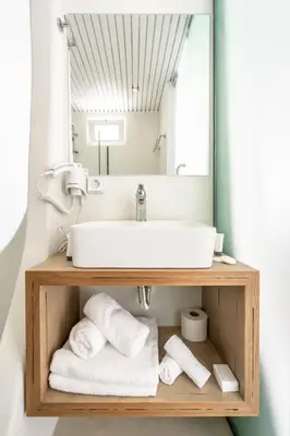a bathroom with a sink and a mirror at Aloe Hotel - Adults Only in Faliraki