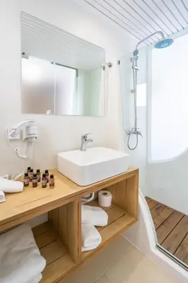 a bathroom with a sink and a mirror at Aloe Hotel - Adults Only in Faliraki