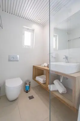 a bathroom with a toilet and a sink at Aloe Hotel - Adults Only in Faliraki
