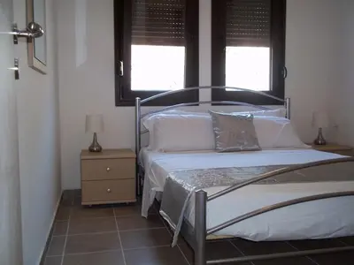 a bedroom with two beds and a window at 3 Bed Villa In Lardos Village in Lardos