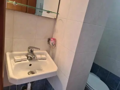 a bathroom with a sink and a toilet at Haraki Sunset Apartment in Haraki