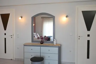 a dressing room with a mirror and a dresser at GianAngelo Holiday Villa in Kremasti