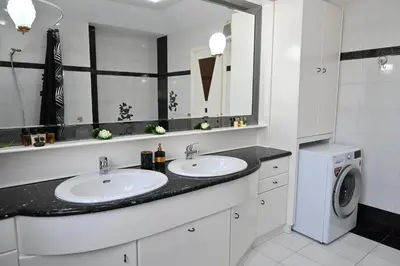 a bathroom with two sinks and a washing machine at GianAngelo Holiday Villa in Kremasti