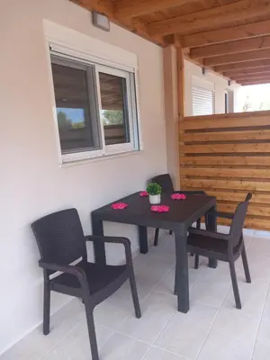 a black table and chairs in a room with a window at Kolymbia summer holidays in Kolimbia