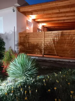 a house with a wooden fence in a garden at Kolymbia summer holidays in Kolimbia