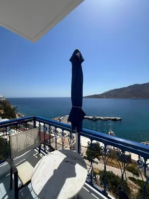 a balcony with a table and a view of the ocean at Marinas Studios in Livadia