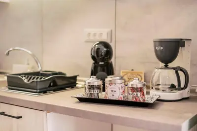 a counter top with a blender and jars on it at Fay's Suites in Ialyssos