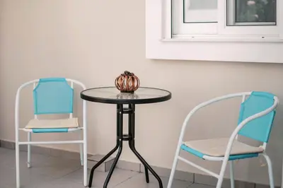 two chairs and a table and a table and chairs at Fay's Suites in Ialyssos