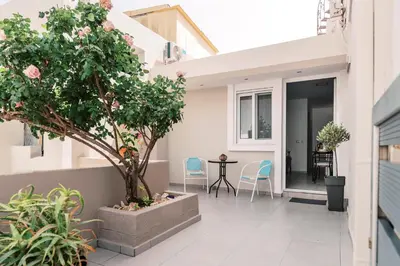 an internal courtyard of a house with a tree at Fay's Suites in Ialyssos