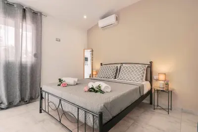 a bedroom with a bed with flowers on it at Fay's Suites in Ialyssos