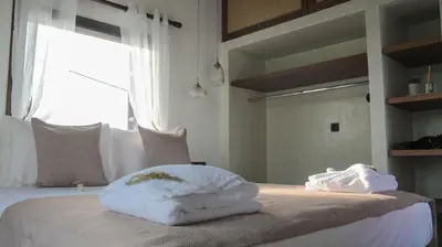 a bedroom with a bed with white towels on it at Villa Nefeli Rhodes in Archangelos