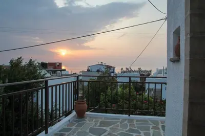 a balcony with a view of the sunset at Villa Nefeli Rhodes in Archangelos