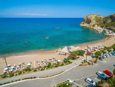 an aerial view of a beach with umbrellas and chairs at Villa Nefeli Rhodes in Archangelos