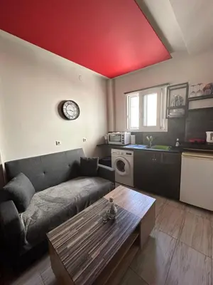a living room with a couch and a red ceiling at Jz boutique 1 in Rhodes Town