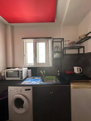 a kitchen with a sink and a washing machine at Jz boutique 1 in Rhodes Town