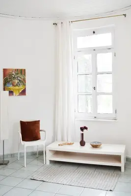 a white living room with a table and a window at Ixia Manor House in Ixia