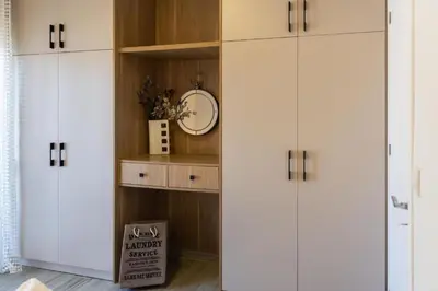 a closet with white cabinets and a box in a room at Charavgi Apartment 1 in Kremasti