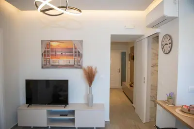a living room with a flat screen tv on a white wall at Charavgi Apartment 1 in Kremasti