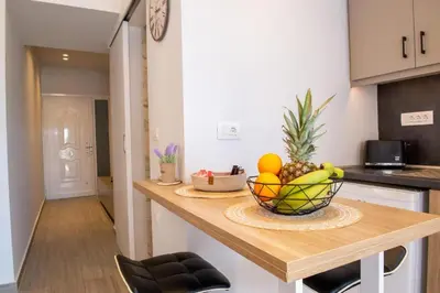 a kitchen with a bowl of fruit on a counter at Charavgi Apartment 1 in Kremasti