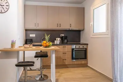 a kitchen with a table with a bowl of fruit on it at Charavgi Apartment 1 in Kremasti