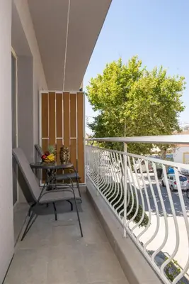 a balcony with a table and chairs on it at Charavgi apartment 2 in Kremasti