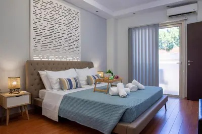 a bedroom with a bed and a large window at Charavgi apartment 2 in Kremasti