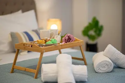 a small table with a tray of food and towels at Charavgi apartment 2 in Kremasti