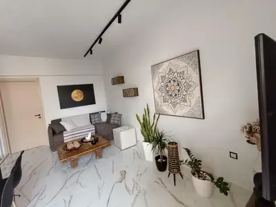 a living room with a couch and a table at Seven Palms Central in Rhodes Town