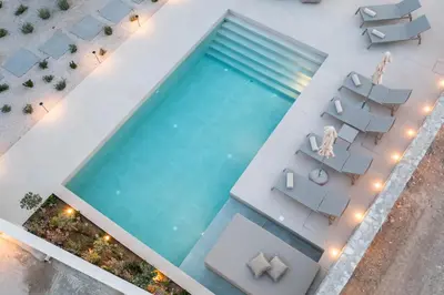 an overhead view of a swimming pool with chairs and tables at Villa Ariadne in Gennadi