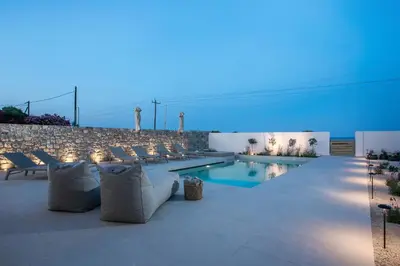 a swimming pool with lounge chairs and a swimming pool at Villa Ariadne in Gennadi