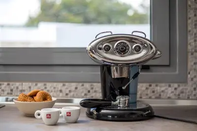 a coffee maker sitting on a counter with a bowl of donuts at Melilia luxury villa in Gennadi